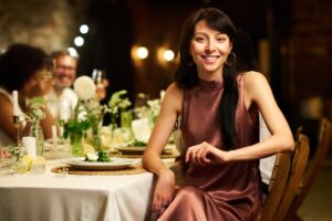 woman sitting at wedding reception table looking into camera