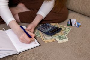 girl budgeting at home on couch