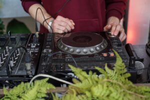 dj turntable and dj's hands on table