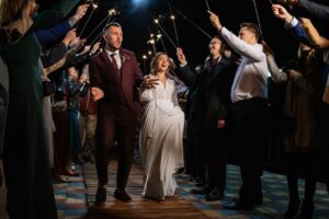 newlyweds at wedding in a corridor of sparklers