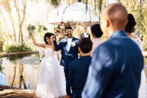 Shot of a happy newlywed young couple walking down the aisle at outdoor venue