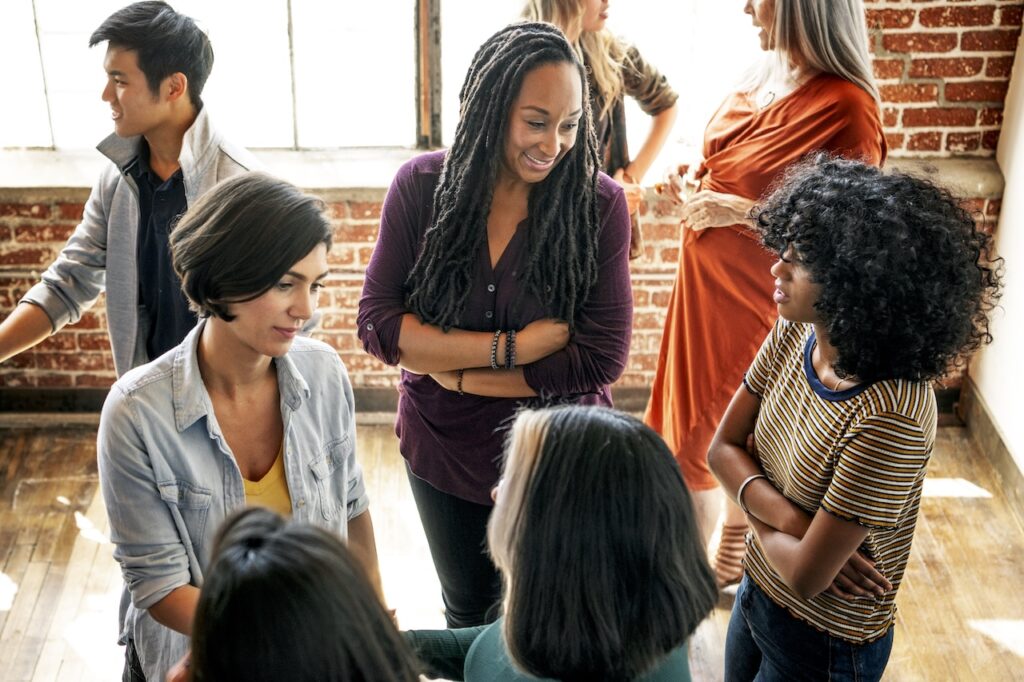 group of friends and family at event talking