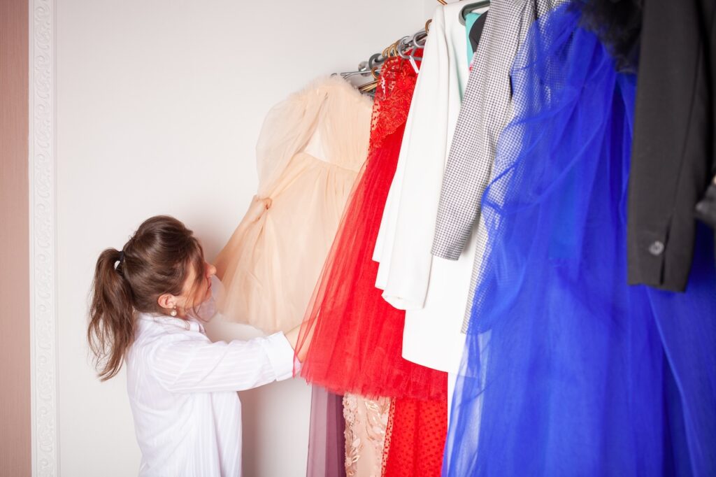 A woman in a clothing store choosing a dress